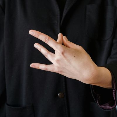 Close-up of a person's hands in a mudra position.